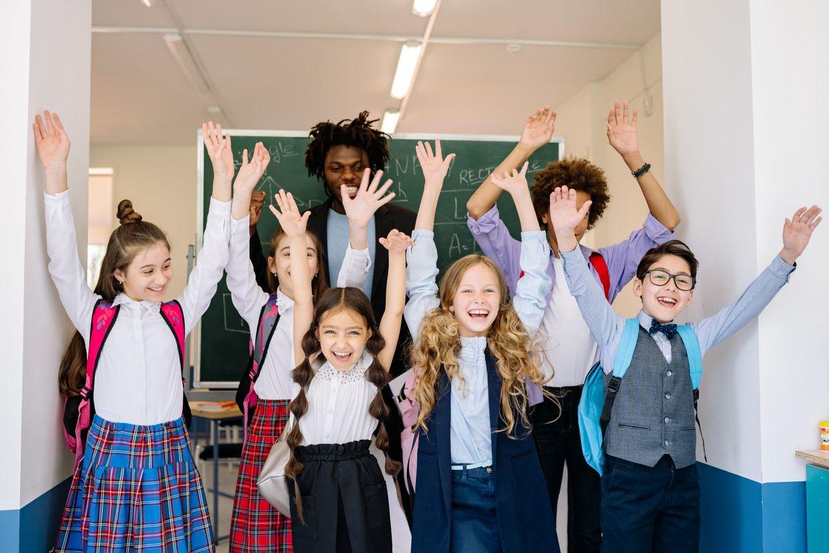 Cheering students with their hands in the air